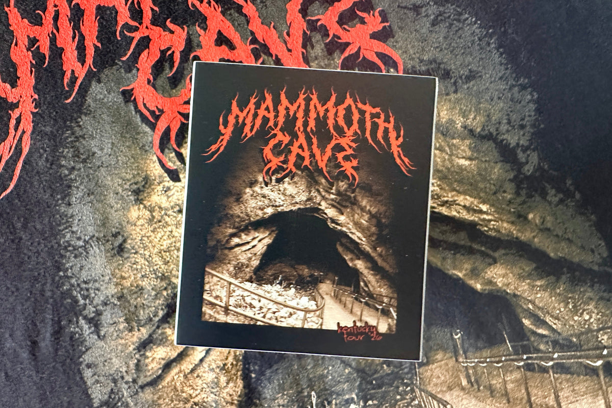 Sticker with a cream and red 'Mammoth Cave' design on a textured background