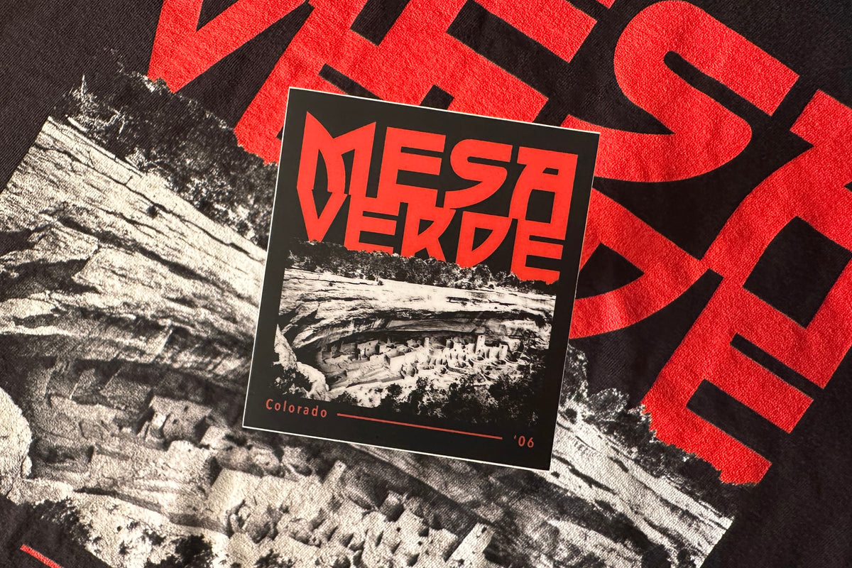 Sticker of Mesa Verde with red text on a black and white background.