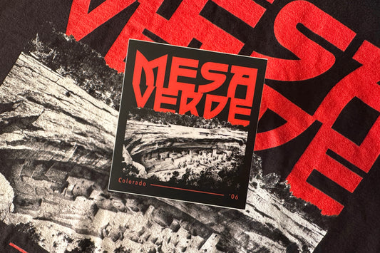 Sticker of Mesa Verde with red text on a black and white background.