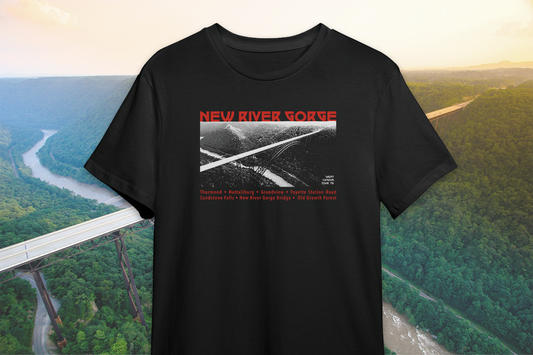 A black t-shirt with a red and white 'New River Gorge' design on a scenic background