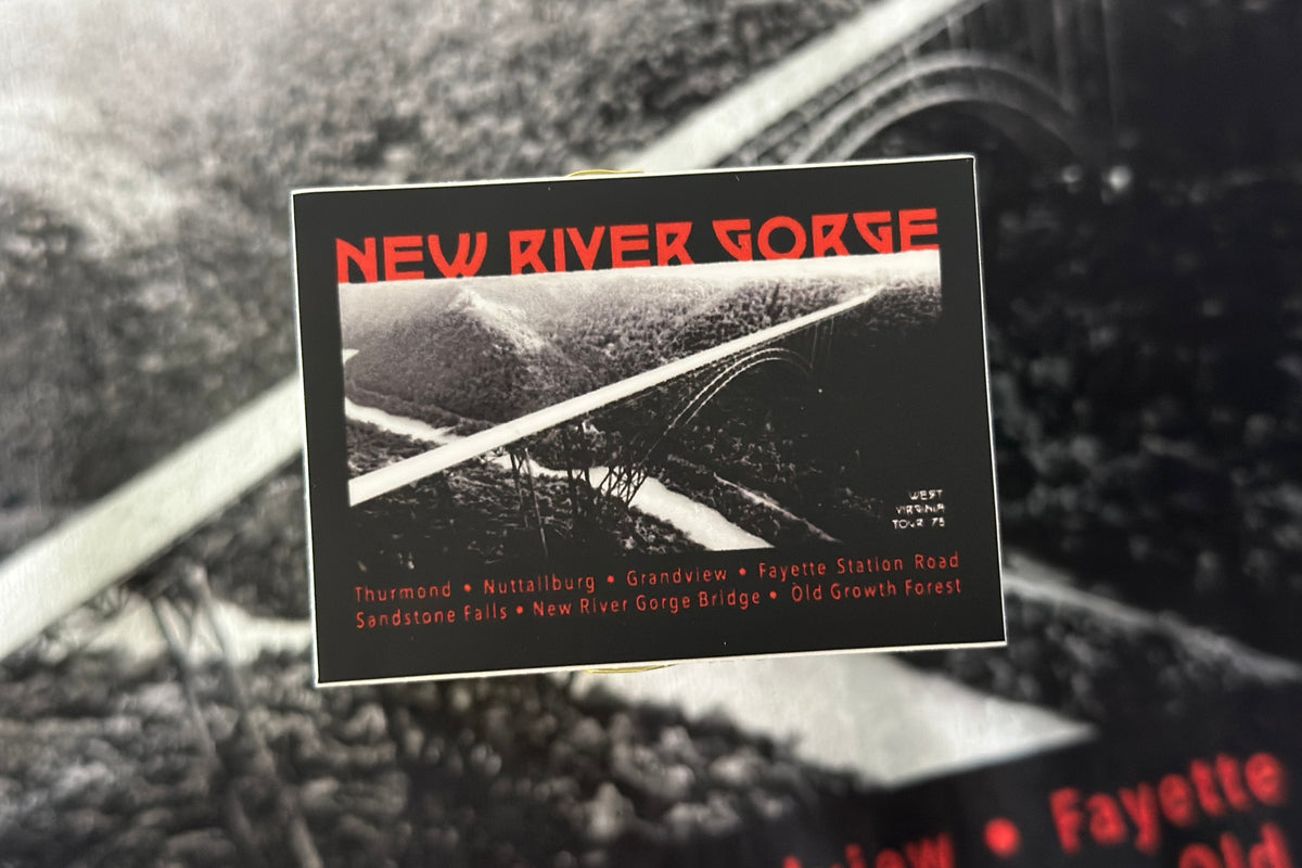 Vintage-style sticker with 'New River Gorge' text and landscape on a black background.