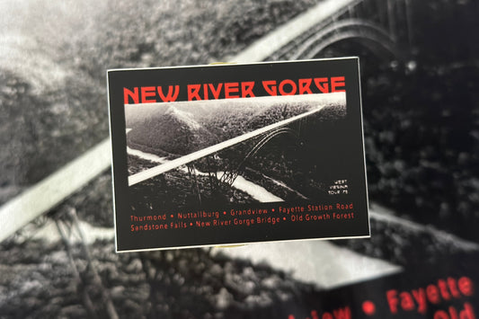 Vintage-style sticker with 'New River Gorge' text and landscape on a black background.