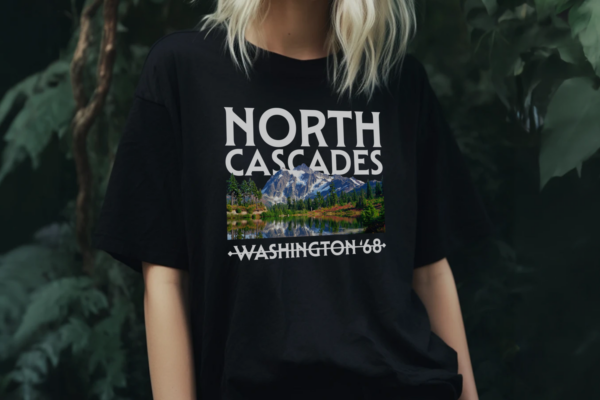 Person wearing a black t-shirt with 'North Cascades Washington 68' graphic design.