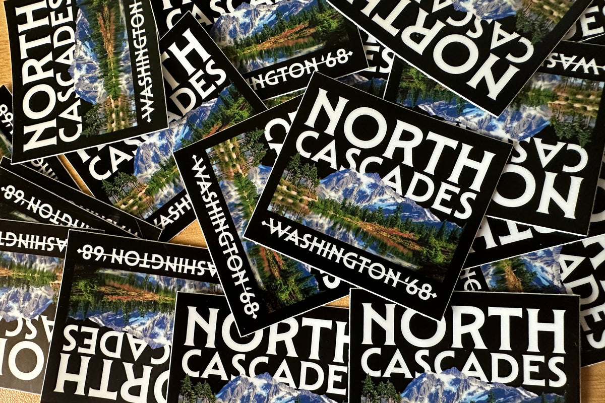 Stickers with 'North Cascades, Washington 68' design featuring mountain landscapes.