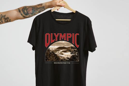 Black t-shirt with 'Olympic' graphic design on a hanger against a white background