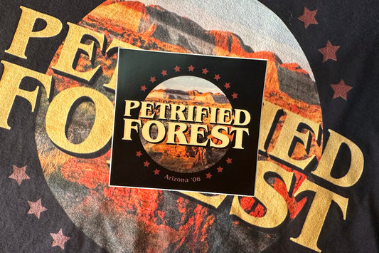 Sticker with 'Petrified Forest' design featuring desert landscape and stars.