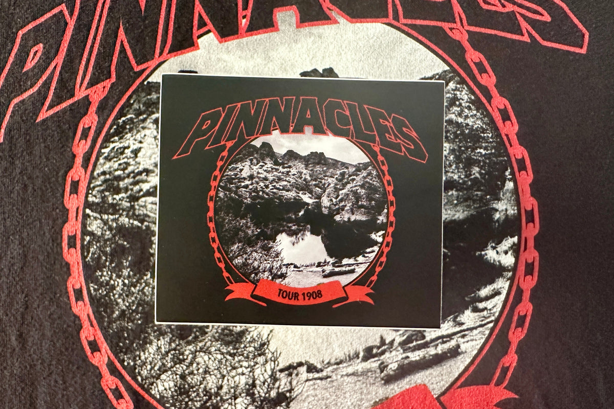 Sticker with a red and white 'Pinnacles' design, on a textured background