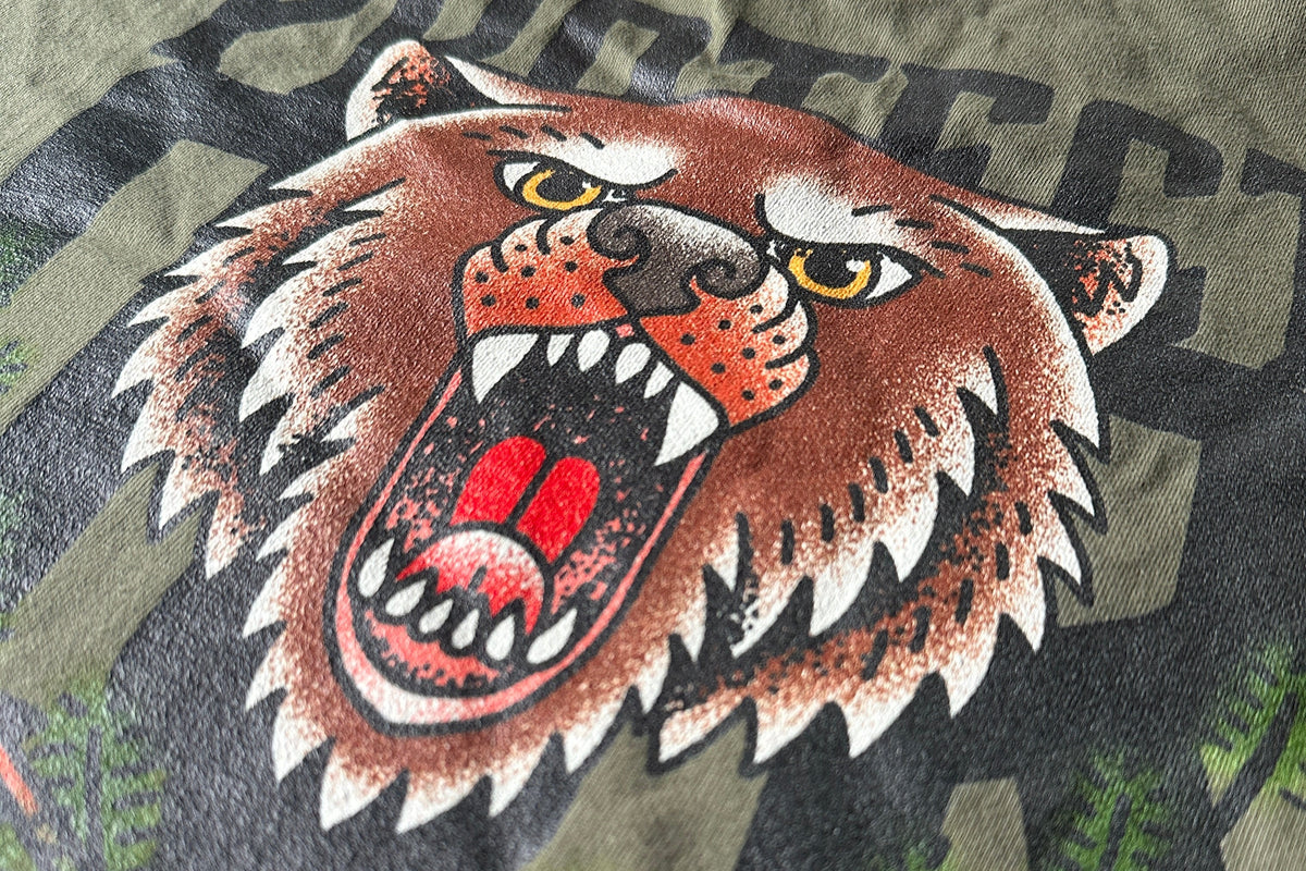 T-shirt with a graphic of a roaring bear and text on a green background