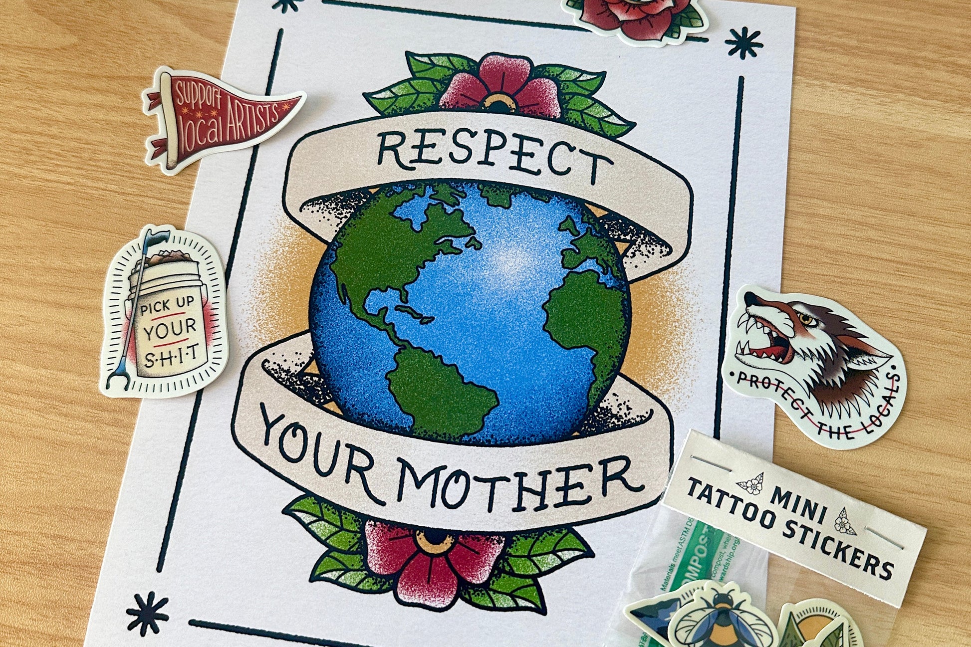 Art print with 'Respect Your Mother' design and other stickers on a wooden surface