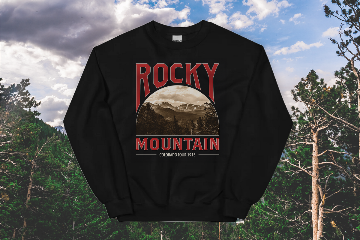 Black sweatshirt with 'Rocky Mountain' graphic design against a forest background