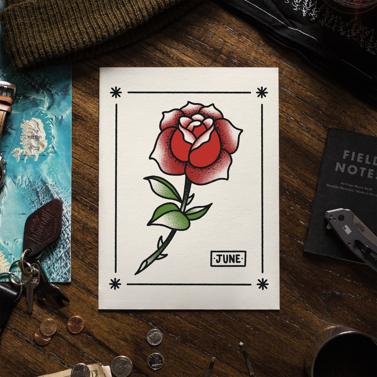 A illustration of a rose, laying on a wooden table