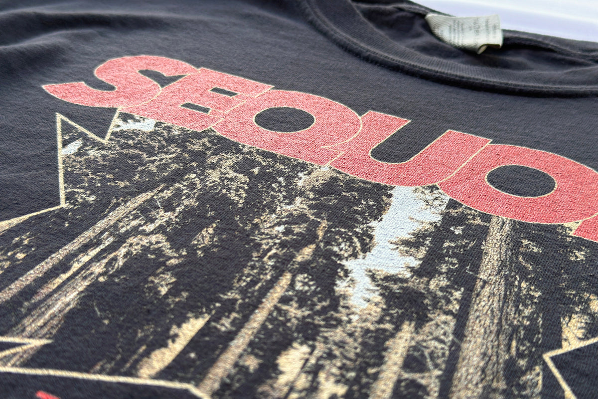 Black t-shirt with red text and forest graphic