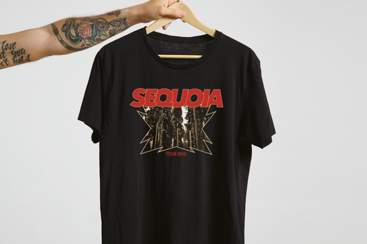 Black t-shirt with red and white graphic design on a hanger against a light gray background