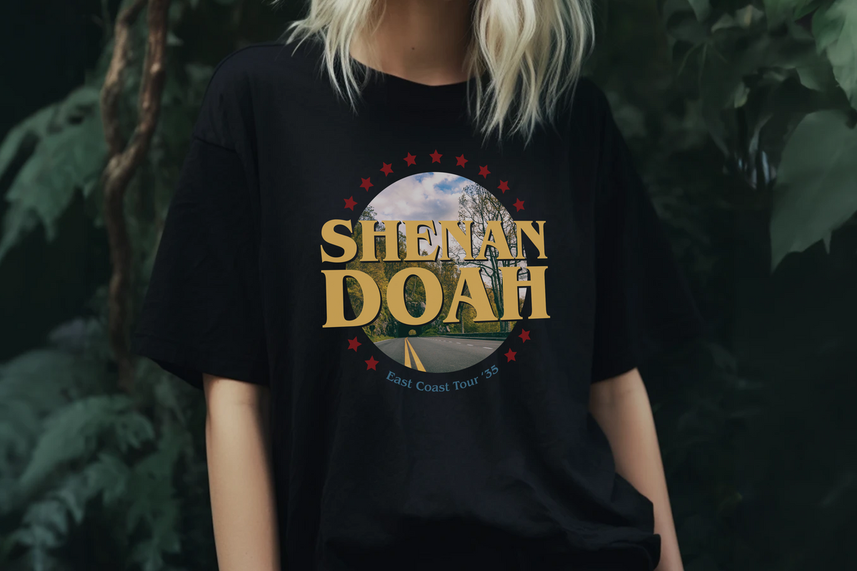 Person wearing a black t-shirt with 'Shenandoah' design against a dark background