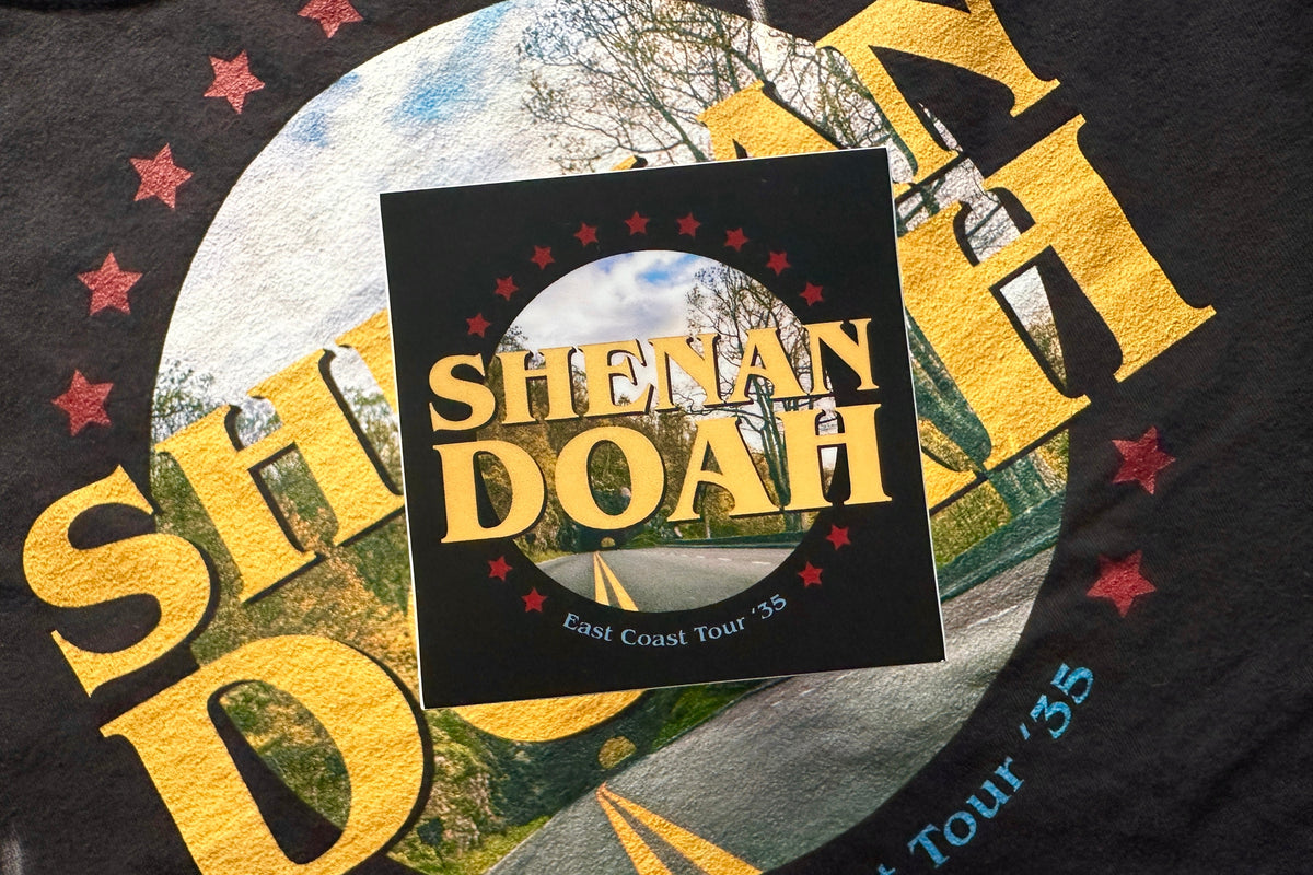 Black sticker with 'Shenandoah' text and a circular design featuring a road and trees.