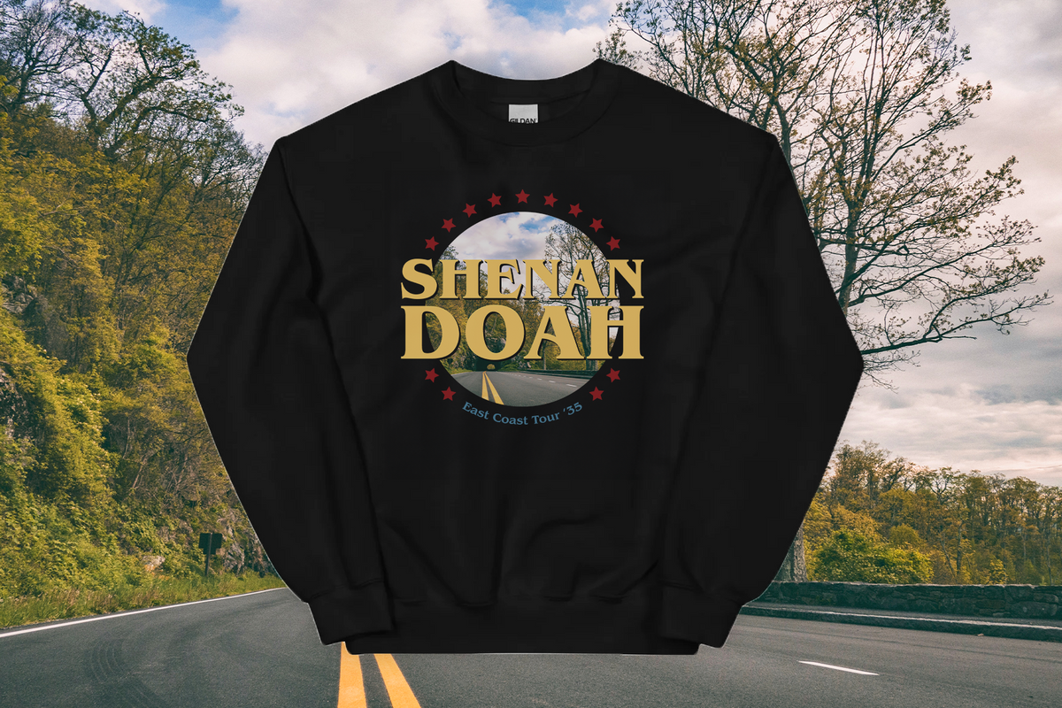 Black sweatshirt with 'Shenandoah' logo on a road with trees in the background