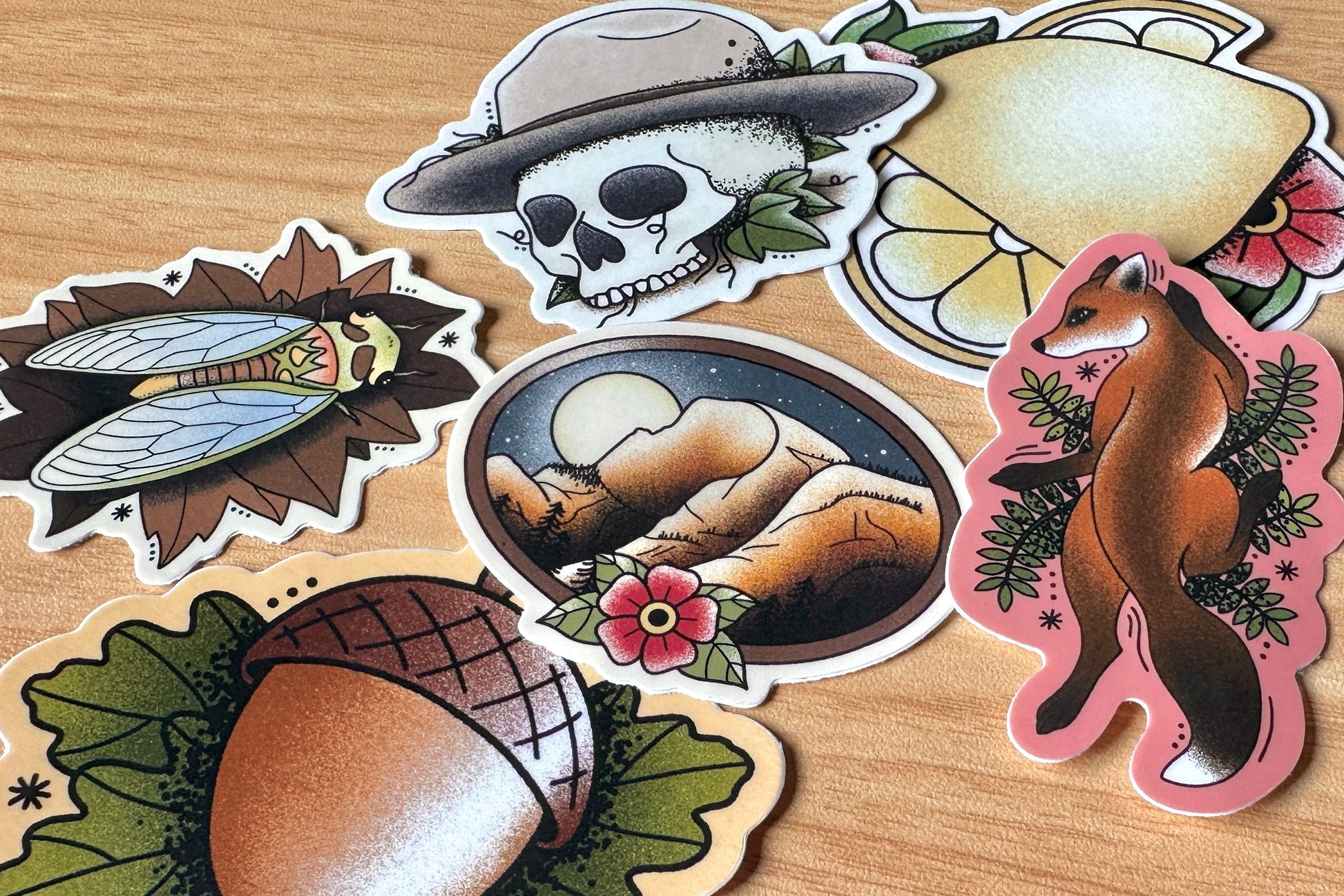 Collection of nature-themed stickers on a wooden surface