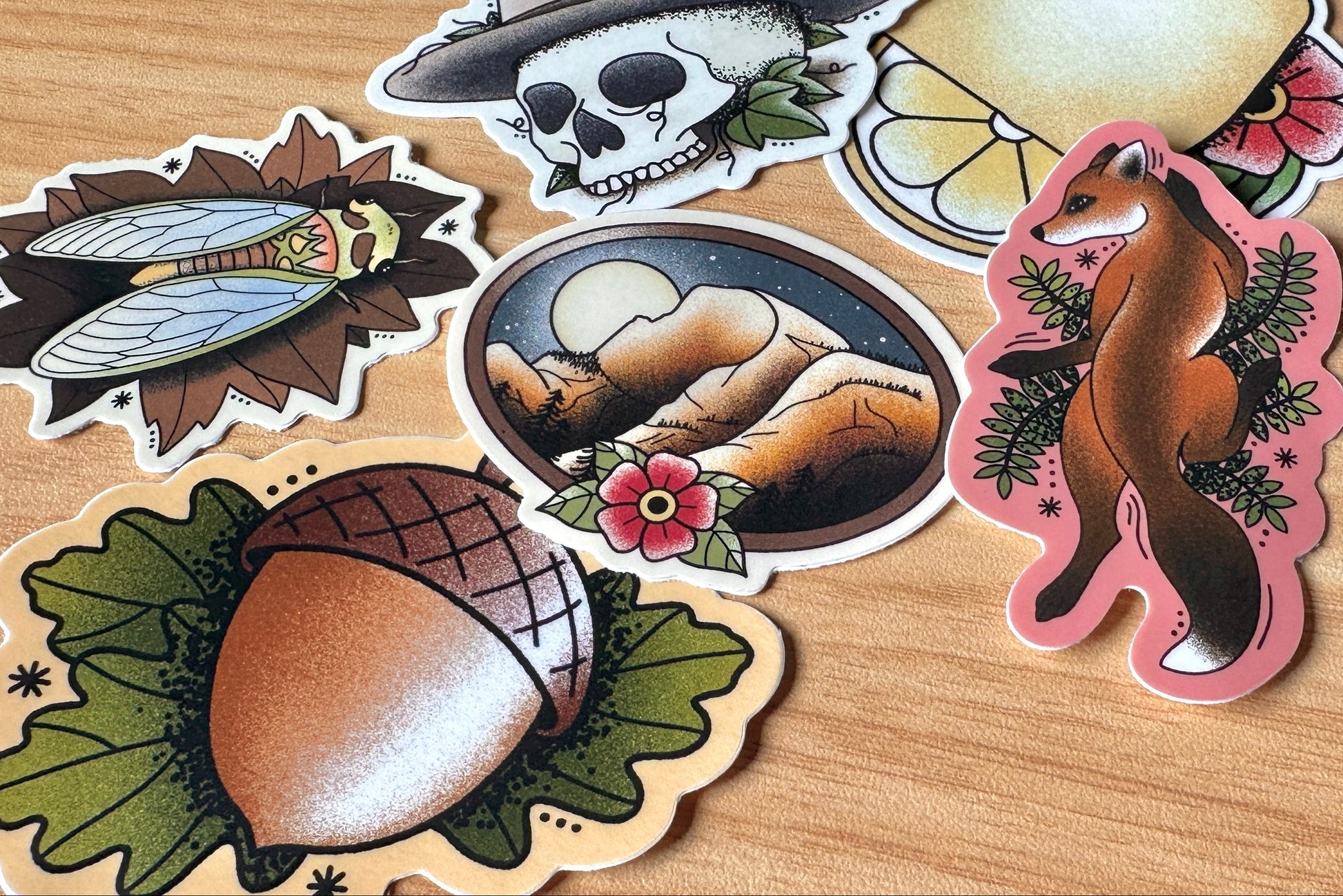 Collection of nature-themed stickers on a wooden surface