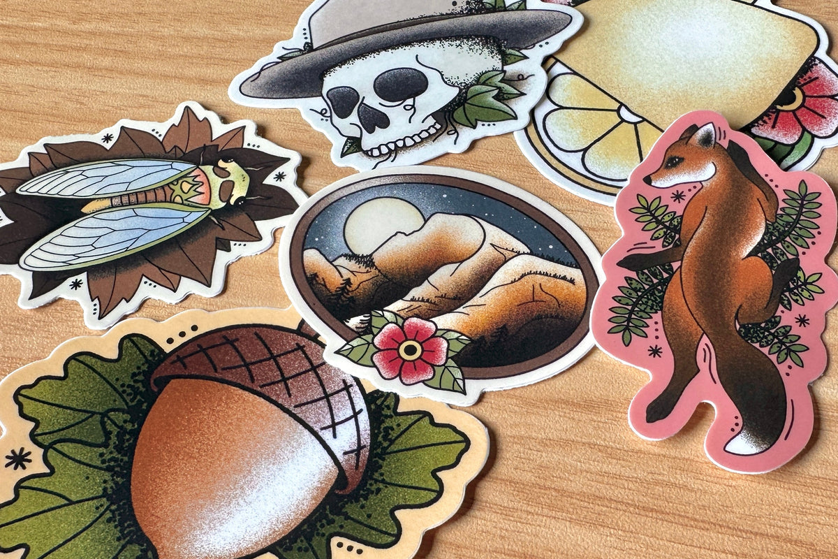 Collection of nature-themed stickers on a wooden surface