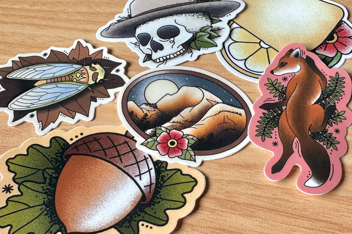 Collection of nature-themed stickers on a wooden surface