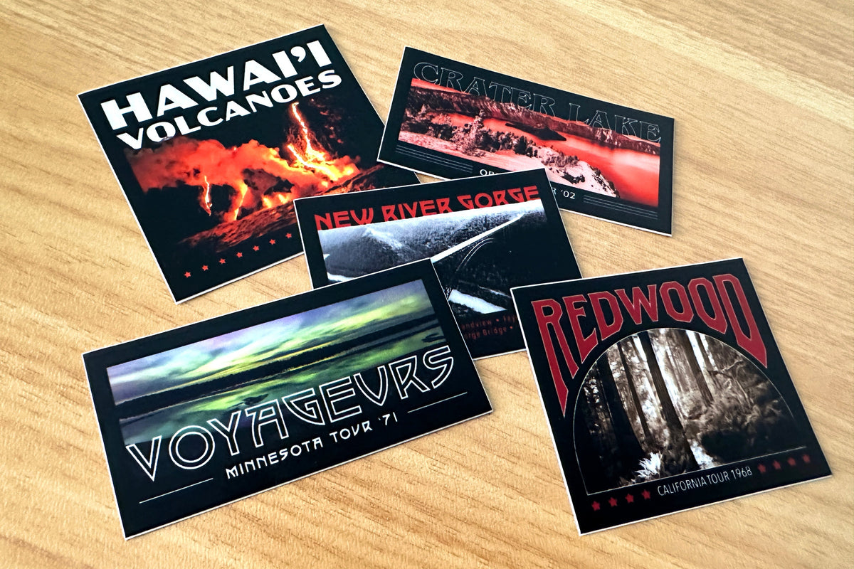 Set of travel-themed stickers on a wooden surface