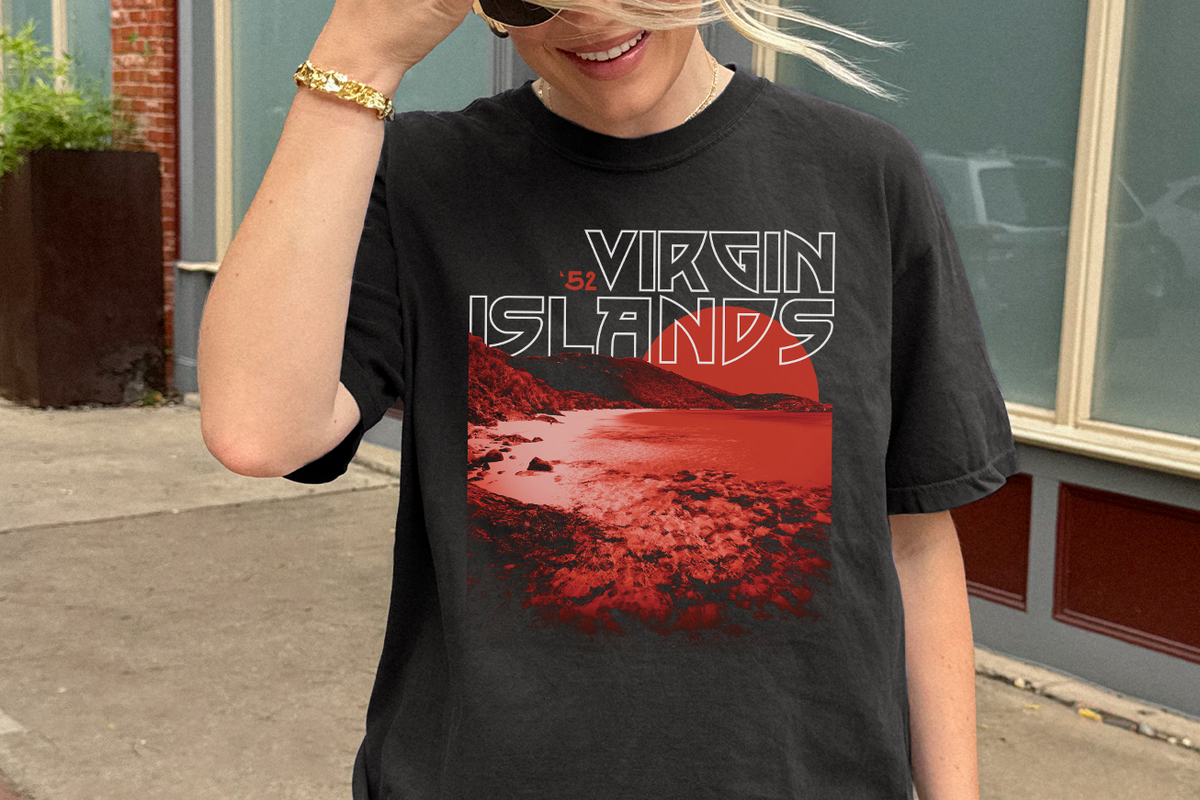 Person wearing a black t-shirt with a red graphic and 'Virgin Islands' text.