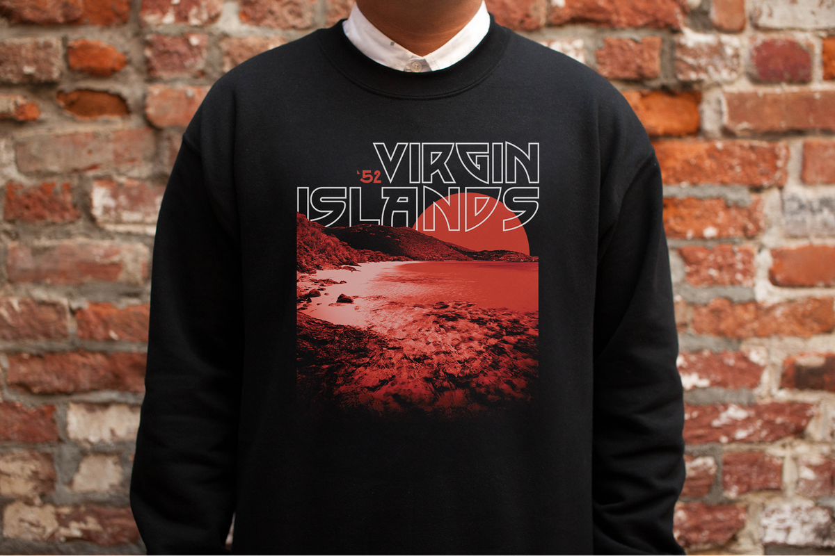 Person wearing a black sweatshirt with 'Virgin Islands' graphic against a brick wall.