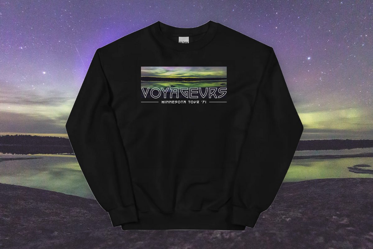 Black sweatshirt with 'VOYAGEURS' logo against a scenic background