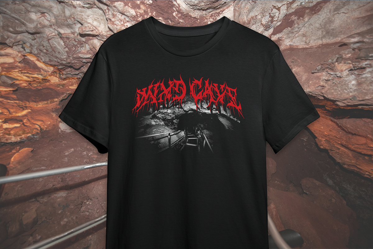Black t-shirt with red and white 'Wind Cave' graphic design on a stone surface