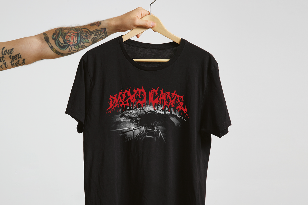 Black t-shirt with red and white 'WInd Cave' graphic design on a hanger against a light gray background