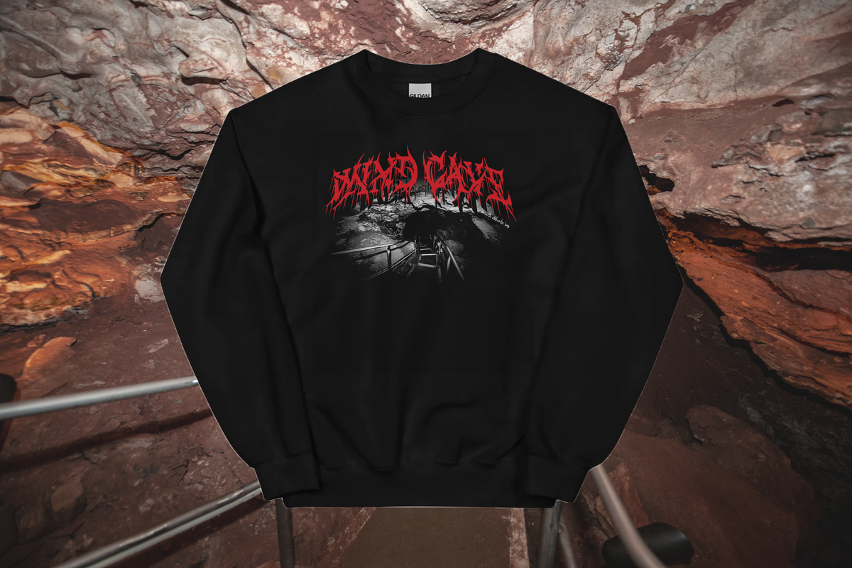 Black sweatshirt with red text and graphic design on a stone wall background
