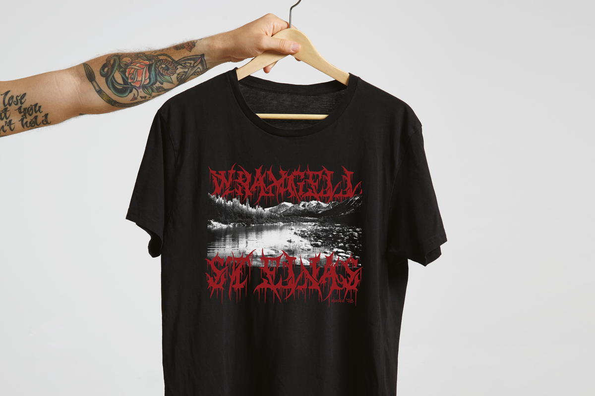 Black t-shirt with red and white 'Wrangell St Elias' graphic design on a hanger against a light gray background