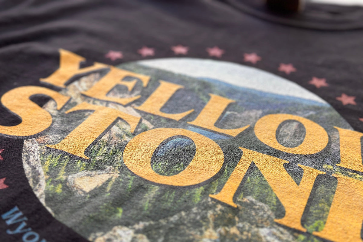 Close-up of a Yellowstone-themed shirt with scenic design