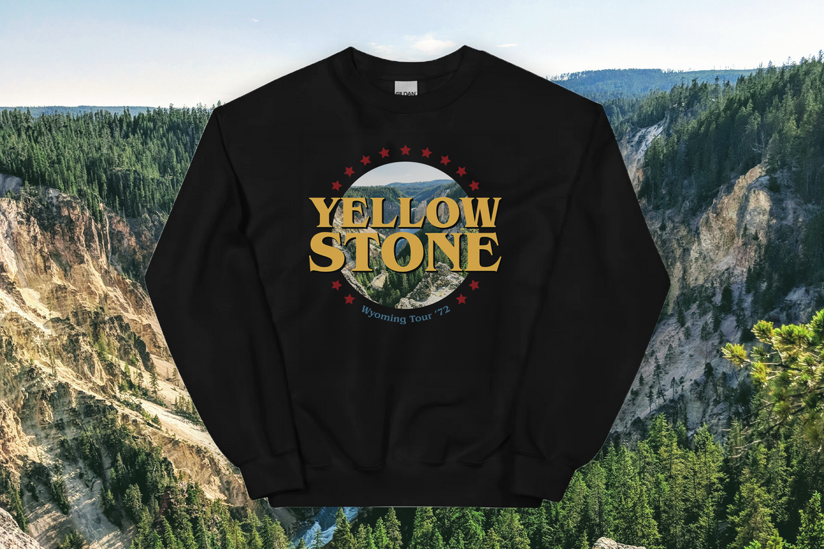 Black sweatshirt with 'Yellowstone' logo against a scenic background