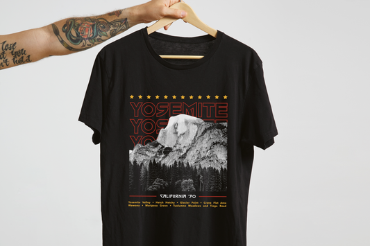 Black t-shirt with Yosemite design on a hanger against a white background