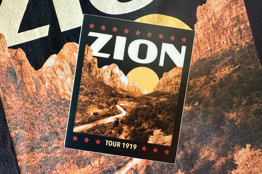 Sticker with a cream colored 'Zion' design, on a textured background
